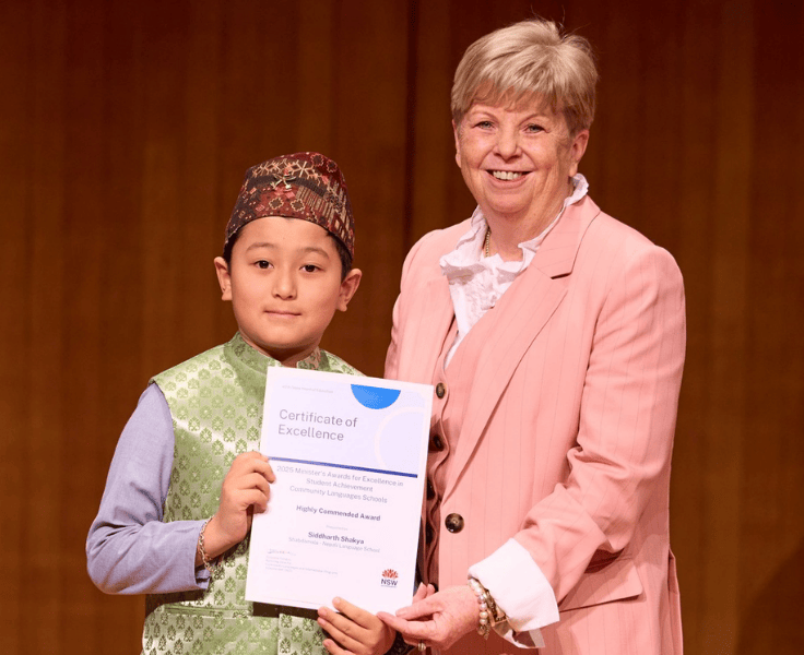 A student receives an award from Dr Sylvia Corish